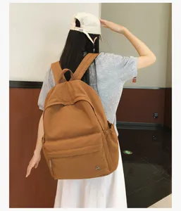 Sac à dos en toile décontracté pour étudiants. Cartable uni élégant avec grande capacité.