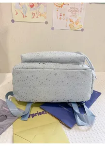 Vue détaillée d'un sac à dos étudiant bleu clair à motif d'étoiles, cartable de loisir.