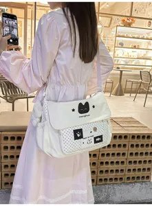 Cute canvas messenger bag for middle school students with black cat pattern and polka dot design.
