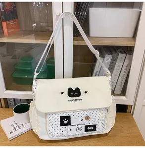 Cute canvas messenger bag with polka dots and cat embroidery, ideal for students and daily use.