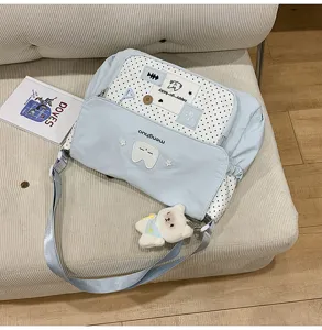 Cute polka dot canvas messenger bag for students, stylish shoulder bag with cute plush pendant.