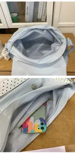 Light blue messenger bag for student daily use featuring multi compartments and stylish design
