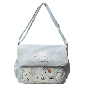 Cute blue polka dot canvas messenger bag for girls, casual adjustable shoulder school bag.