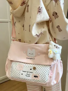 Cute pink polka dot canvas messenger crossbody bag for students, stylish school shoulder bag.