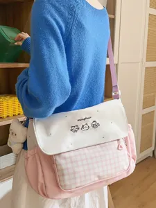 Bolso bandolera de lona a cuadros rosas con bonito bordado de gato y correa escolar.
