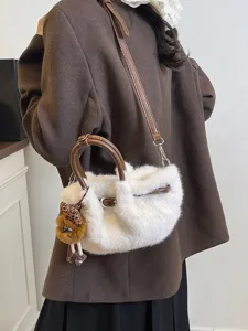Chic winter plush bucket bag for women, soft faux fur shoulder bag with stylish brown handles.