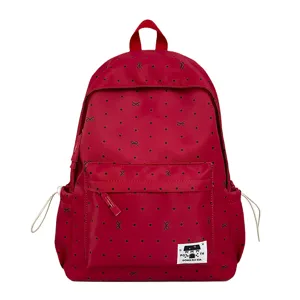 Roter Schülerrucksack Detail mit schwarzem Pünktchen- und Schleifenmuster sowie Fronttasche.