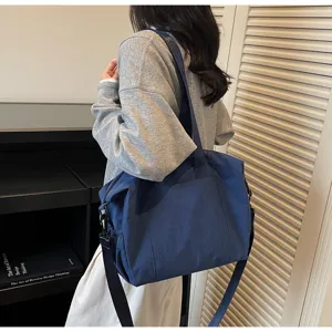 Large capacity blue canvas tote bag, stylish minimalist shoulder bag for outdoor travel.