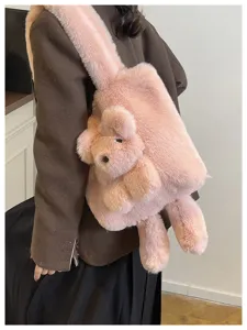 Cute pink plush shoulder bag detail showing soft fluffy texture and adorable cartoon animal design.