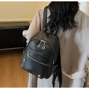 Detailed view of women's black PU leather mini backpack worn on back, ideal for daily commuting.