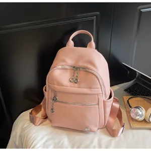Stylish pink PU leather women backpack, spacious casual daypack for daily commute and school use.