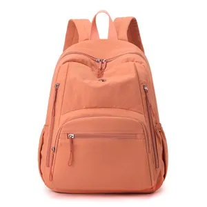 Vue de détail du sac à dos en nylon imperméable, cartable rose pêche pour le quotidien.