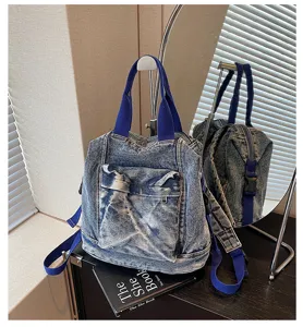 Washed denim backpack with blue straps and front pocket detail, stylish and casual daily use.