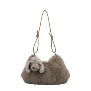 Plush underarm bag detail view, soft faux fur texture with cute rabbit pendant, stylish and cozy.