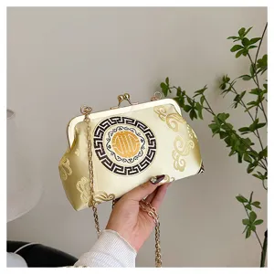 Detail view of Chinese style evening bag featuring intricate cloud patterns and clasp design.