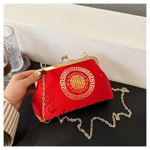 Exquisite detail of red Chinese style cloud pattern evening bag with gold chain and clasp.