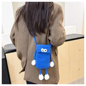 Cute handmade knit phone bag with funny googly eyes, stylish blue crossbody bag for women.