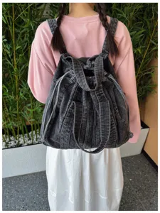 Vue détaillée du sac à dos rétro en denim lavé décontracté avec un design multi-bretelles.