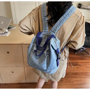 Detailed view of stylish washed denim women backpack showing casual daily setup and pockets.