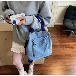 Casual denim backpack for women, stylish large capacity school bag with blue straps.