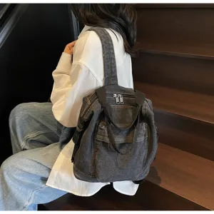 Washed denim backpack detail showing durable fabric texture and large capacity daily style.