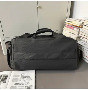Detail view of dark grey large capacity duffel travel bag, sturdy woven fabric material.