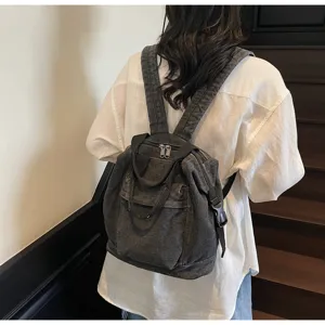 Detail view of washed denim women backpack, casual large capacity daily school bag, dark grey.