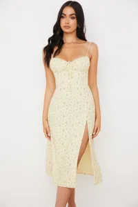 Close-up of floral print spaghetti strap dress, featuring a chic front slit and delicate tie.