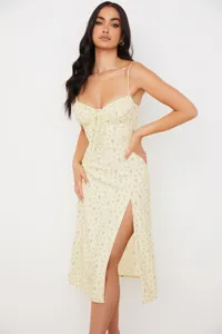 Yellow floral slip dress detail highlighting sweetheart neckline, bust ruching, and leg slit.