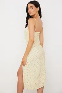 Chic yellow floral slip dress with side slit detail, perfect for summer casual wear.