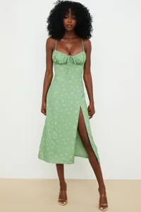 Green floral spaghetti strap midi dress detail, featuring a cute front slit and chic neckline.
