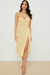 Yellow floral spaghetti strap split midi dress, featuring charming gathered bust and chic design.