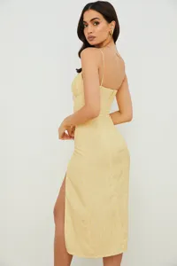 Close-up detail view of the elegant yellow floral camisole dress featuring side slit.