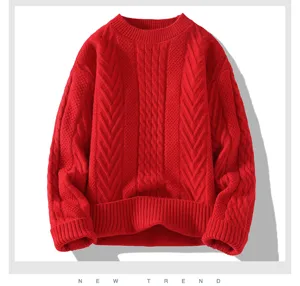 Primo piano del maglione rosso con motivo a trecce, che mostra una trama morbida e accogliente.