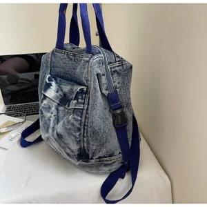 Detailed view of washed denim women backpack, blue straps and side buckle design for daily use.