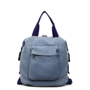 Detailed view of casual denim backpack for women, showing durable fabric texture and stitches.