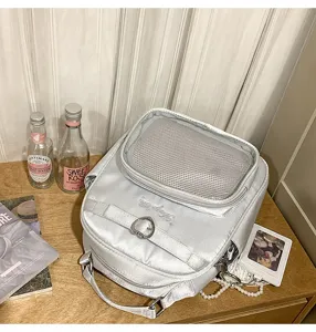 Silver Harajuku style backpack detail showing mesh top pocket, heart metal clasp, and embroidery.
