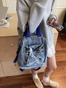 Stylish acid wash denim backpack for women, large capacity casual student school bag.