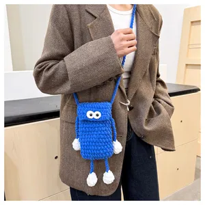 Handmade cute knit phone bag with big eyes, stylish blue crochet crossbody bag for women daily.