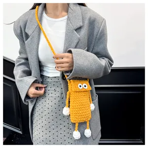 Handmade crochet yellow phone bag with cute big eyes and limbs detail view for women daily style.