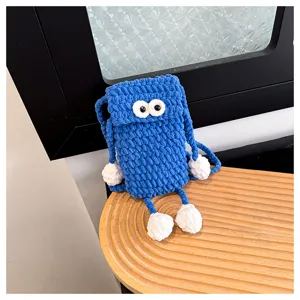 Handmade crochet cute blue phone bag with big eyes and limbs detail shot for women daily use.