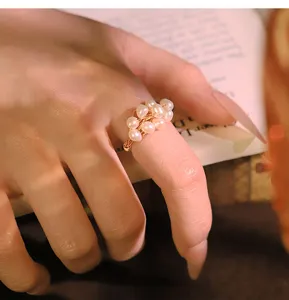 Close-up detail of handmade freshwater pearl ring worn on hand, elegant and stylish accessory.