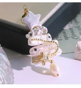 Exquisite baroque pearl Christmas tree pendant detail, featuring sparkling zircons and gold stars.