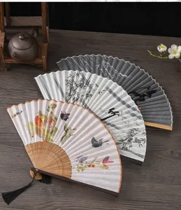 Traditional Chinese folding fan with elegant floral and ink painting designs, bamboo ribs.