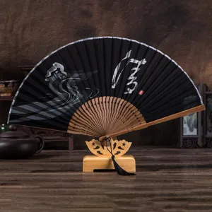 Handmade folding fan with black fabric and wooden ribs, elegant gift for men and home decor detail