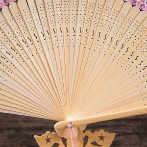Exquisite Chinese folding fan with hollow-out bamboo ribs and elegant lace trim, perfect detail.