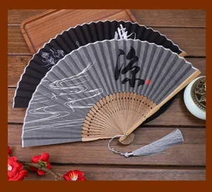 Traditional Chinese folding fan with linen fabric surface, bamboo ribs and tassel pendant.