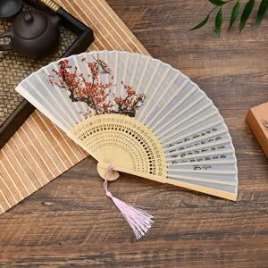 Traditional Chinese folding fan with plum blossom and calligraphy, wooden frame, pink tassel.