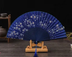 Exquisite vintage blue silk folding fan featuring cherry blossom pattern, wooden stand and tassel.