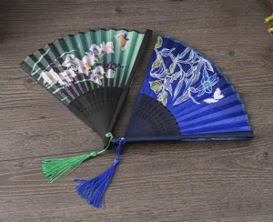 Traditional Chinese style folding hand fan with elegant floral pattern and tassel for dance or props